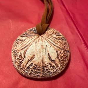 Used But On Good Condition Made Of Clay on a cord.